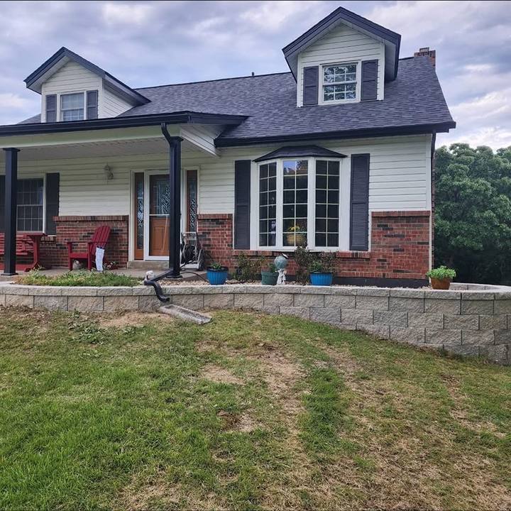 Finished front landscaping with a block wall