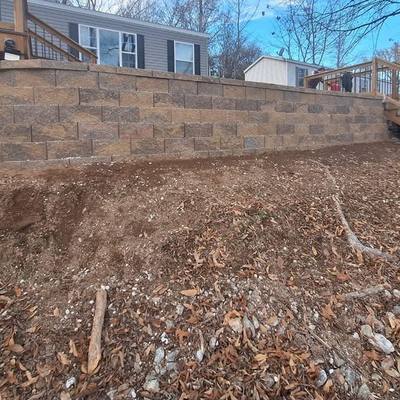 New block retaining wall holding back the backyard slope